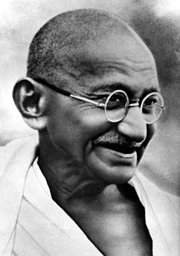 Photograph of Gandhi, smiling, with round glasses