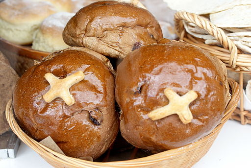 Photograph of a basket of buns with a large cross marked on each.