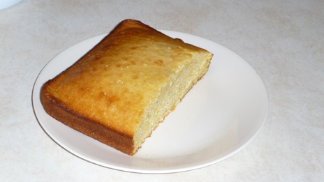 Photograph of serving, showing golden brown crust and yellow crumb.