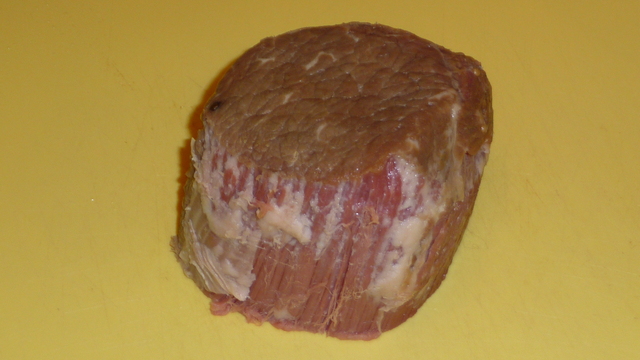 Photograph of corned beef, showing tender pink meat.